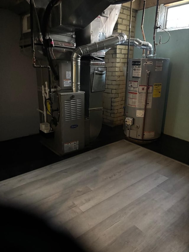 utility room featuring heating unit and water heater