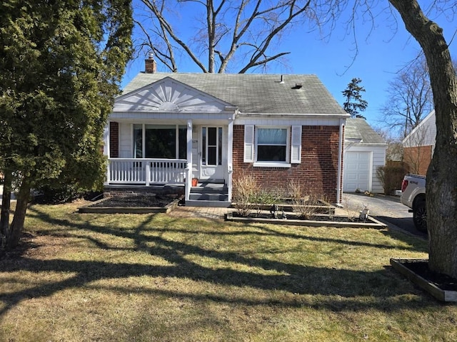 bungalow-style house featuring a front yard, covered porch, a chimney, an outdoor structure, and brick siding