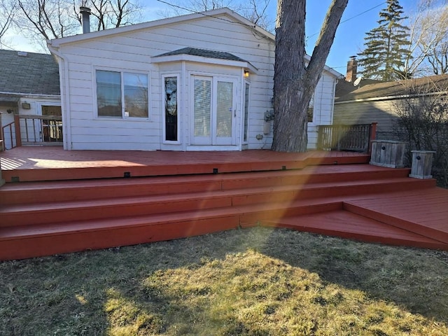 back of property with a wooden deck