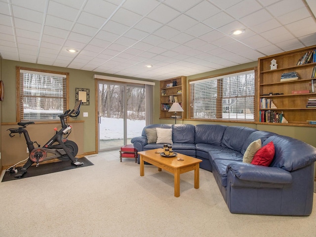 carpeted living room featuring baseboards, built in features, and recessed lighting