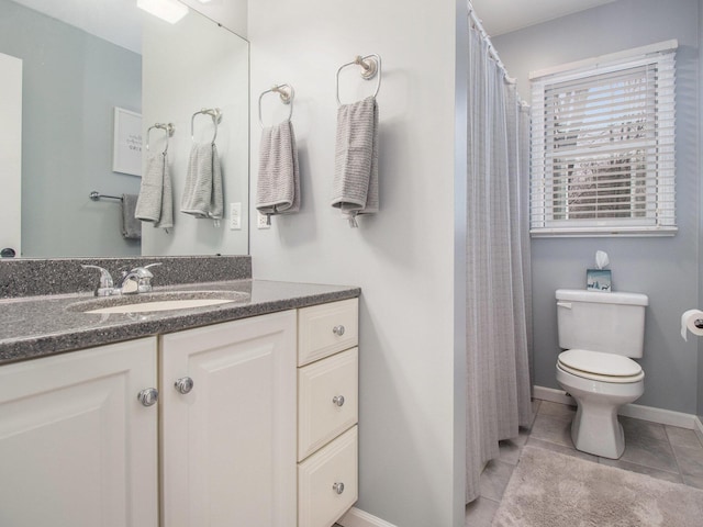 full bath with tile patterned flooring, baseboards, vanity, and toilet