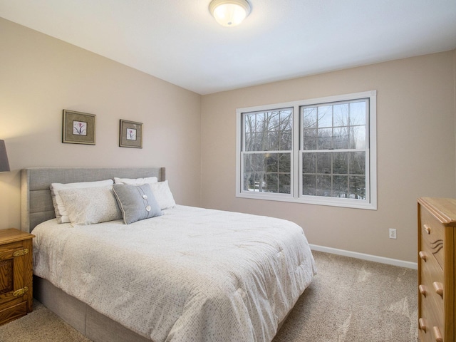 carpeted bedroom with baseboards