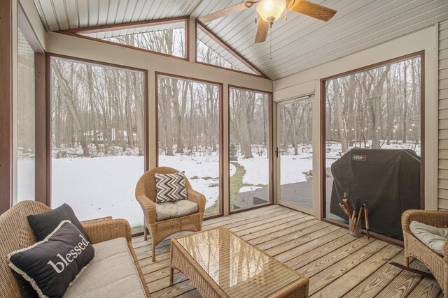 sunroom featuring lofted ceiling and ceiling fan