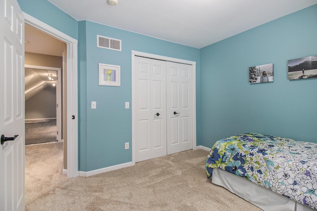 bedroom with a closet, carpet flooring, visible vents, and baseboards