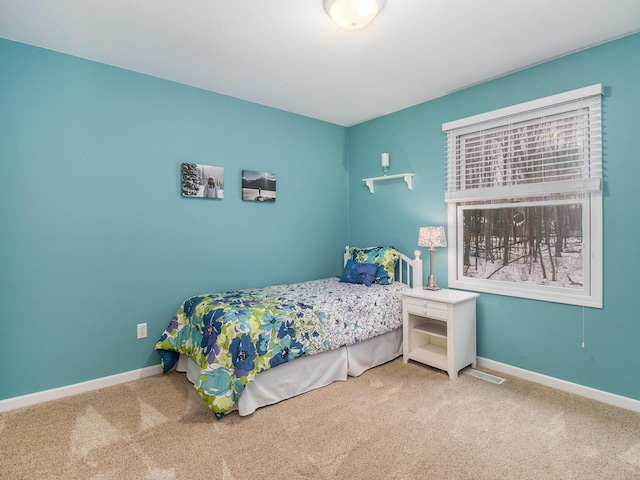 bedroom featuring baseboards and carpet flooring