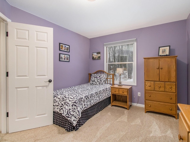 bedroom featuring carpet and baseboards