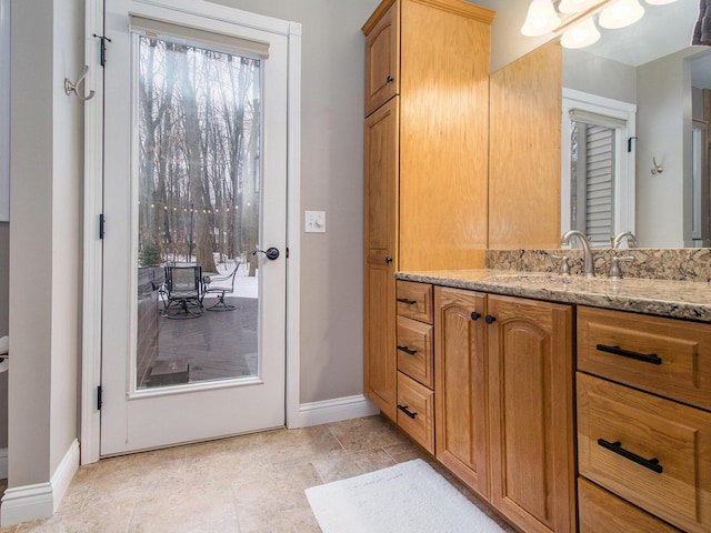 bathroom featuring vanity and baseboards