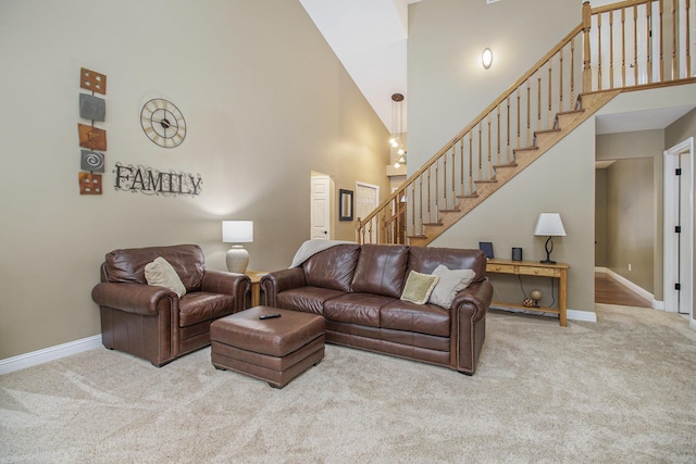 living area with carpet, baseboards, stairway, and a high ceiling