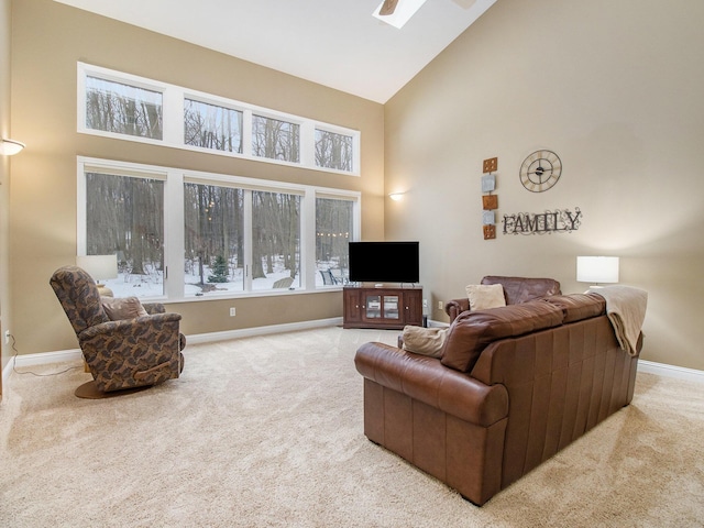 carpeted living room featuring high vaulted ceiling and baseboards