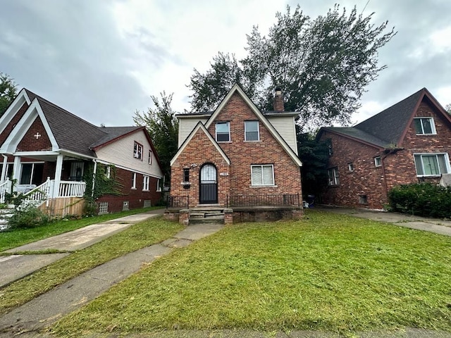 9183 Bishop St, Detroit, MI 48224 - view of front of home featuring brick siding, a front lawn, and a chimney