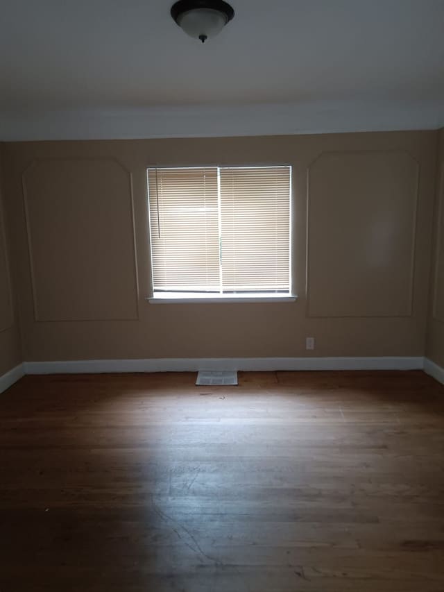 9183 Bishop St, Detroit, MI 48224 - unfurnished room featuring baseboards, visible vents, and wood finished floors
