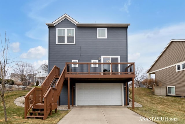 view of front of home featuring a deck, concrete driveway, a front yard, and a garage