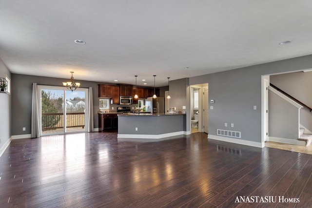 unfurnished living room featuring dark wood-style floors, visible vents, stairway, a chandelier, and baseboards