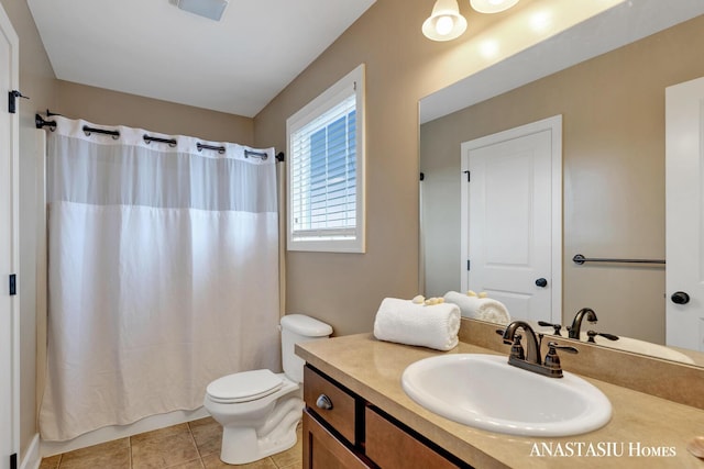 bathroom with tile patterned flooring, a shower with curtain, vanity, and toilet