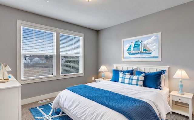 bedroom with visible vents, baseboards, and carpet flooring