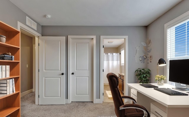 office area featuring light carpet and visible vents