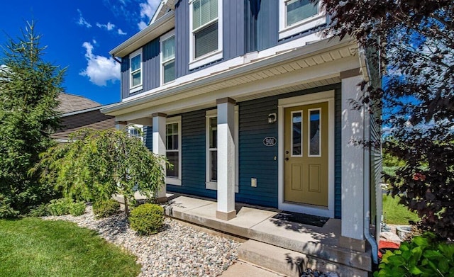 doorway to property featuring a porch and board and batten siding