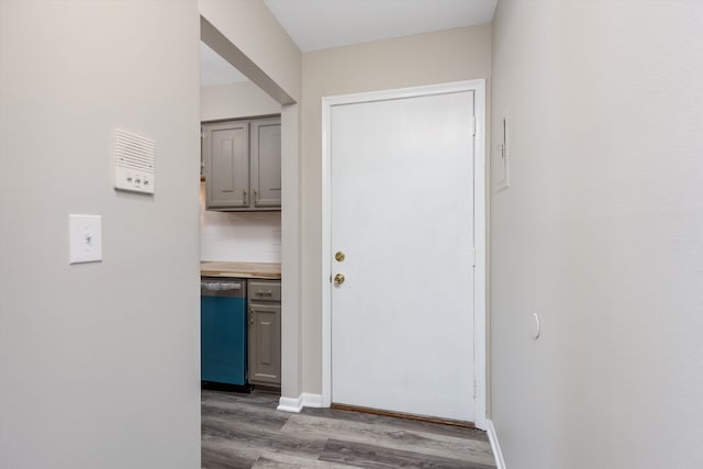 hall with baseboards and wood finished floors