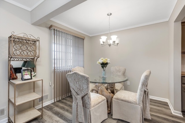 dining room featuring an inviting chandelier, baseboards, visible vents, and wood finished floors