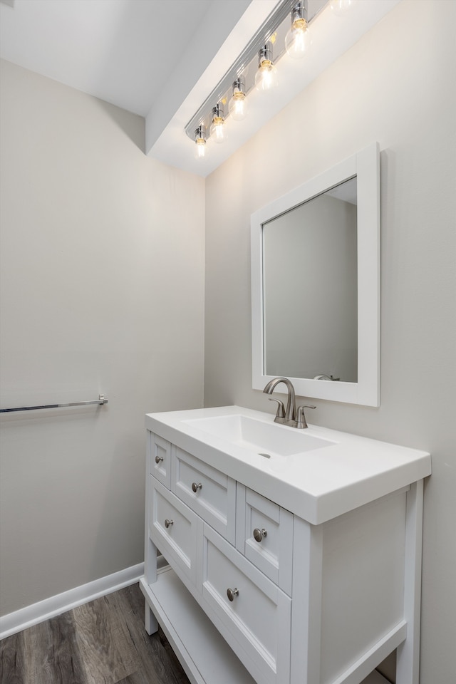 bathroom featuring wood finished floors, vanity, and baseboards