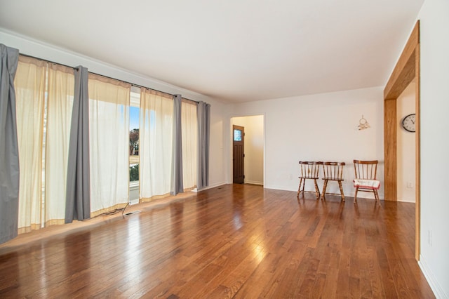 spare room with hardwood / wood-style flooring and visible vents