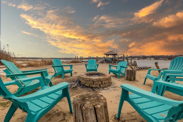 surrounding community with a gazebo and an outdoor fire pit