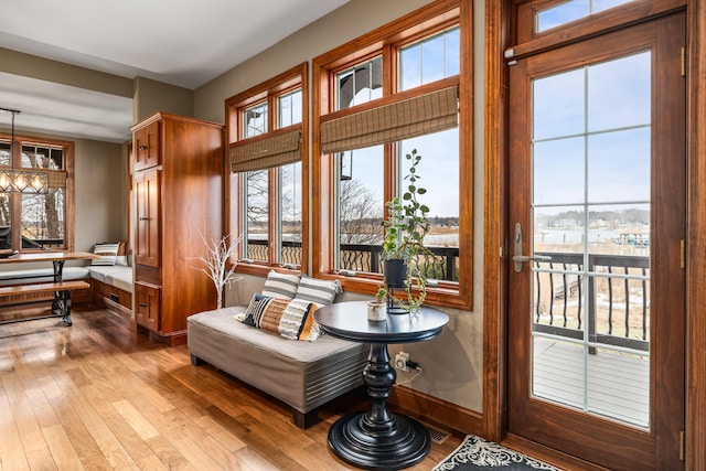 sitting room featuring hardwood / wood-style floors, a wealth of natural light, and baseboards