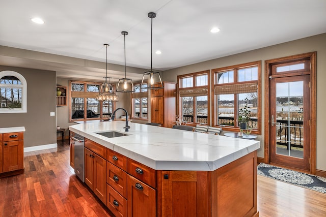 kitchen featuring a wealth of natural light, dark wood-style flooring, a sink, and brown cabinetry