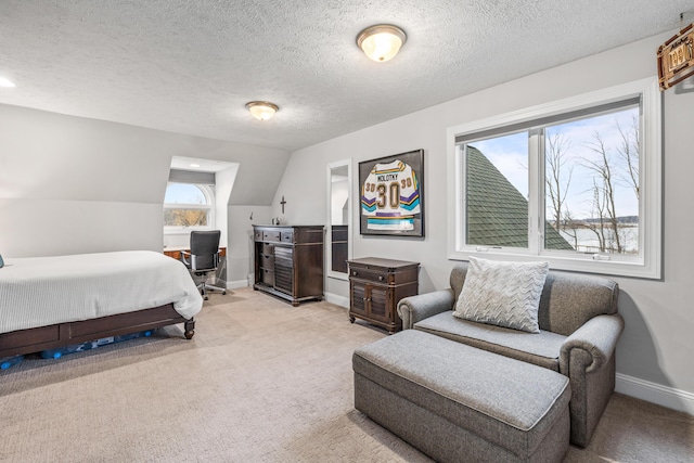 bedroom featuring lofted ceiling, baseboards, a textured ceiling, and light colored carpet