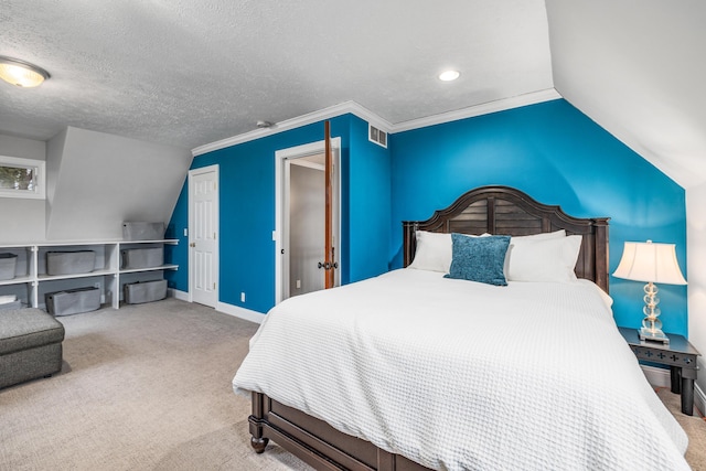 carpeted bedroom featuring a textured ceiling, lofted ceiling, visible vents, baseboards, and crown molding