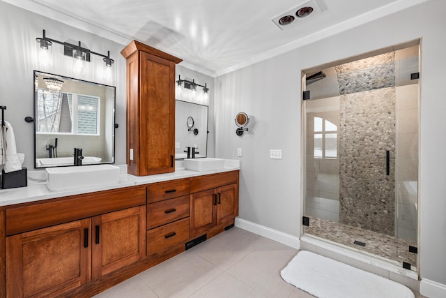 bathroom with a stall shower, tile patterned floors, a sink, and double vanity