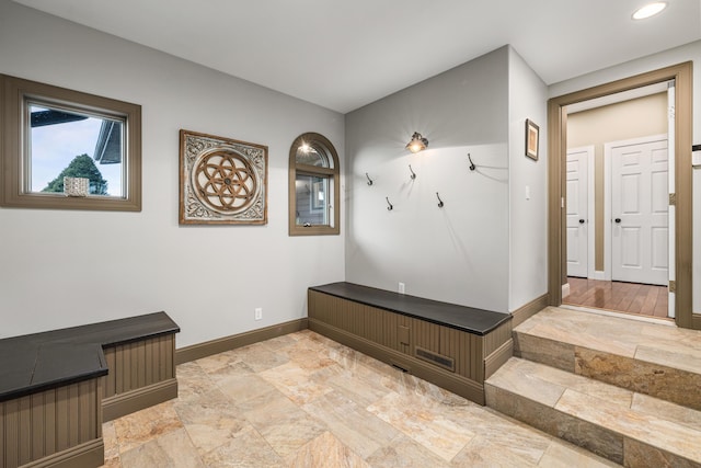 mudroom featuring stone finish floor, baseboards, and recessed lighting