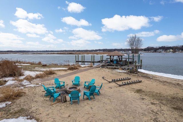 exterior space with a fire pit and a boat dock