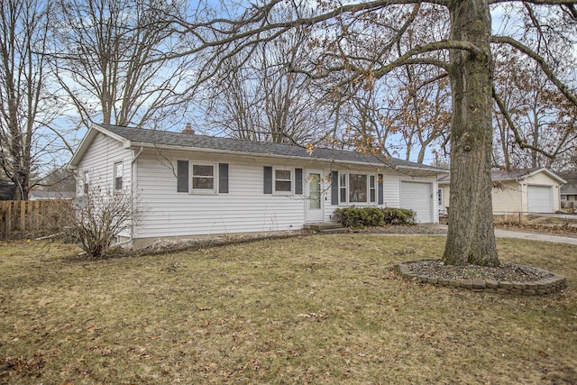 ranch-style home with a front yard, fence, a chimney, and an attached garage