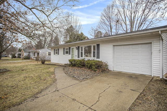 single story home with an attached garage, concrete driveway, and a front yard