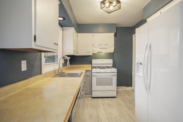 kitchen featuring white appliances, white cabinets, light countertops, under cabinet range hood, and a sink