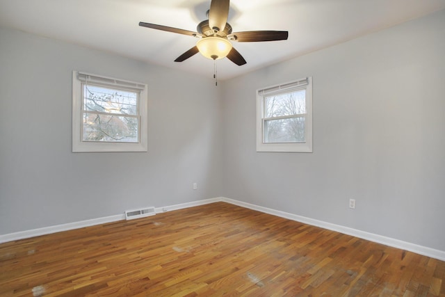 spare room with light wood-type flooring and baseboards