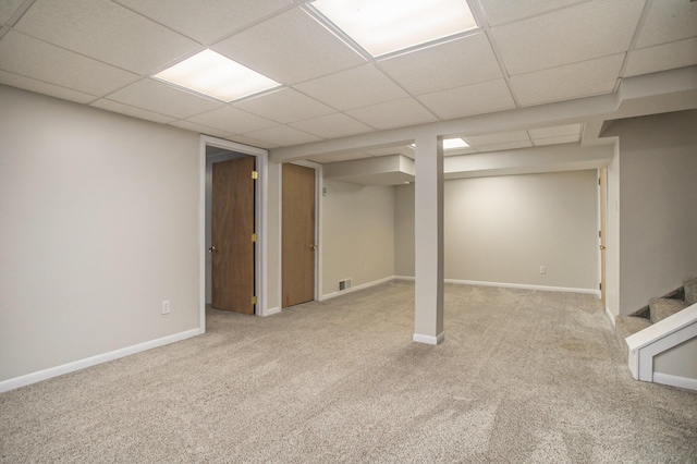 finished basement with carpet, stairs, visible vents, and baseboards