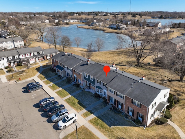 drone / aerial view with a water view and a residential view