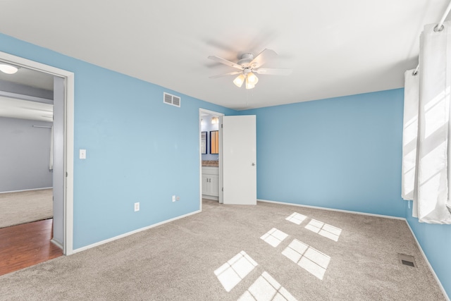 unfurnished bedroom featuring carpet, visible vents, and baseboards