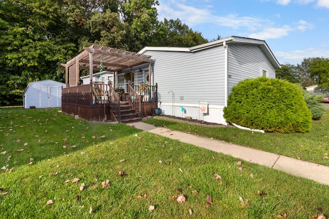 view of front of property with an outbuilding, a wooden deck, a storage shed, a pergola, and a front lawn