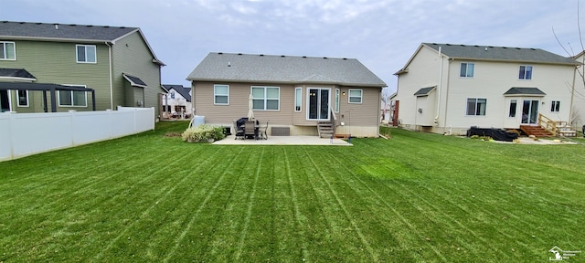 rear view of property with a lawn, central AC unit, entry steps, a patio area, and fence