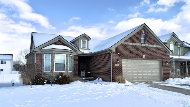 view of front of property featuring a garage and brick siding