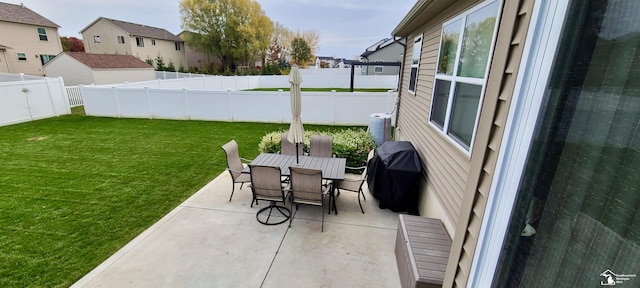 view of patio featuring outdoor dining space, a residential view, a fenced backyard, and area for grilling