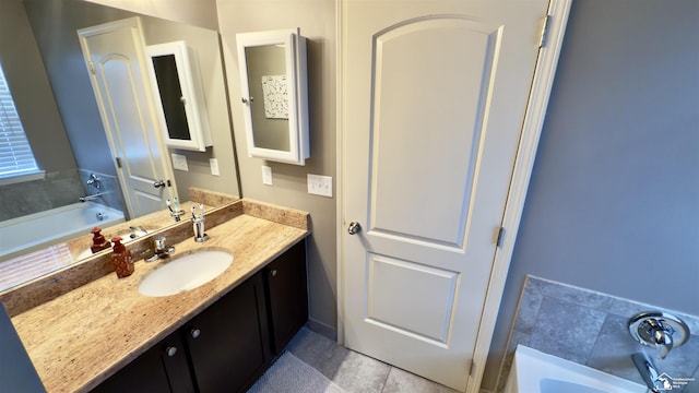 bathroom featuring a garden tub and vanity