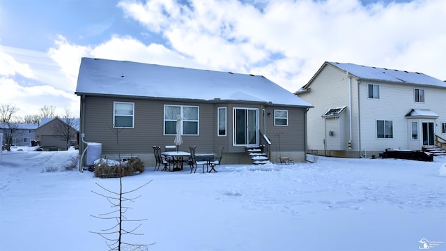 snow covered property featuring entry steps