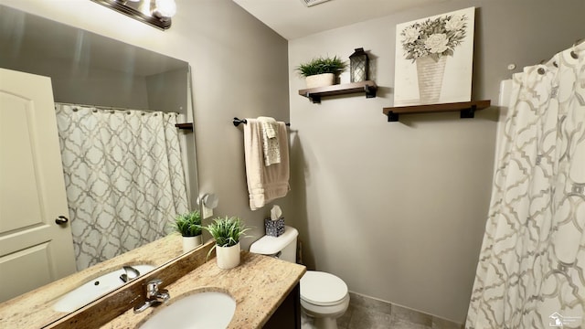 bathroom featuring toilet, tile patterned flooring, a shower with shower curtain, and vanity