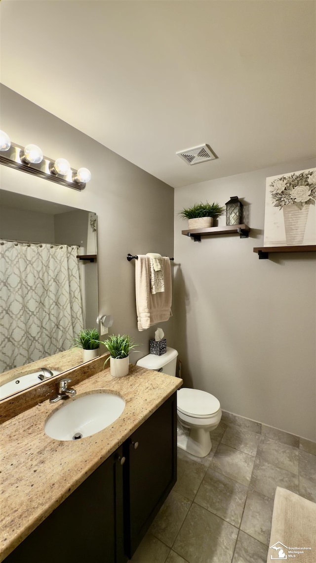 bathroom featuring toilet, visible vents, and vanity