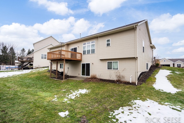 rear view of property featuring a deck and a yard