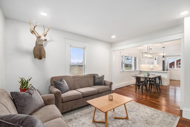 living room with a healthy amount of sunlight, light wood-style floors, and recessed lighting